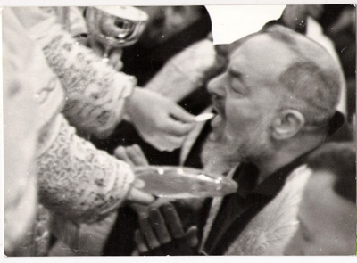 Padre Pio receives communion